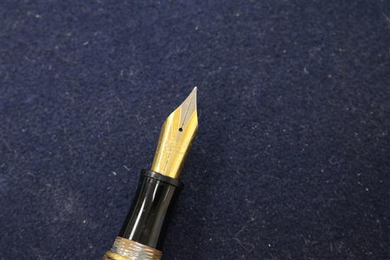 Three ornate fountain pens, cased